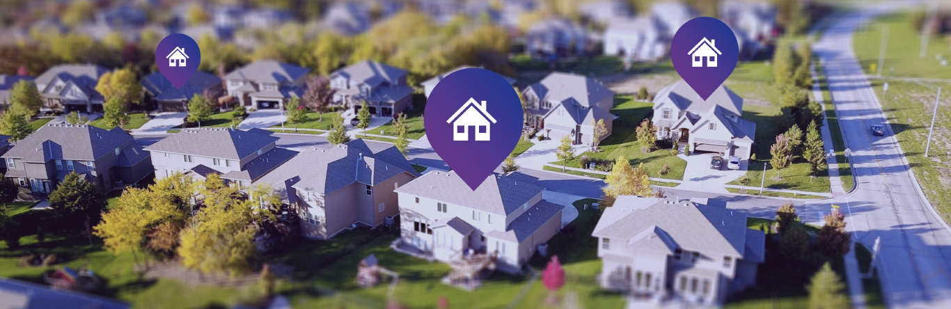 Aerial photo of neighborhood with map pins hovering over three houses