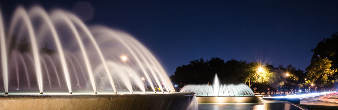 fountains in pond at night time